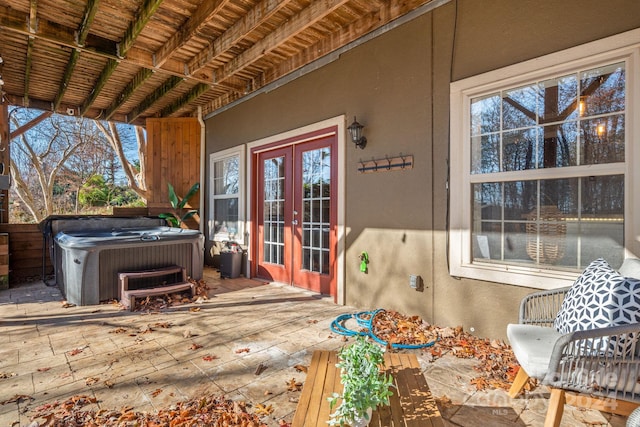 wooden deck featuring french doors and a hot tub