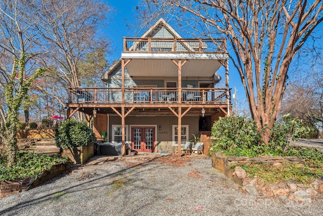 view of property featuring french doors and a wooden deck