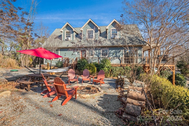 exterior space featuring a fire pit and a wooden deck