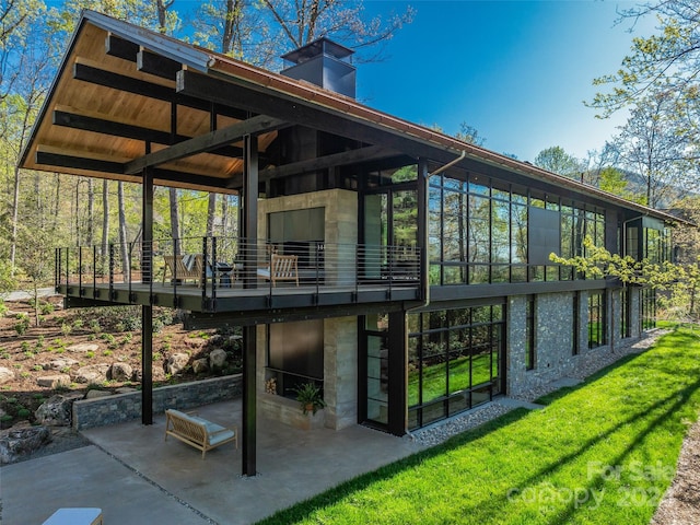 back of property with a patio and a lawn