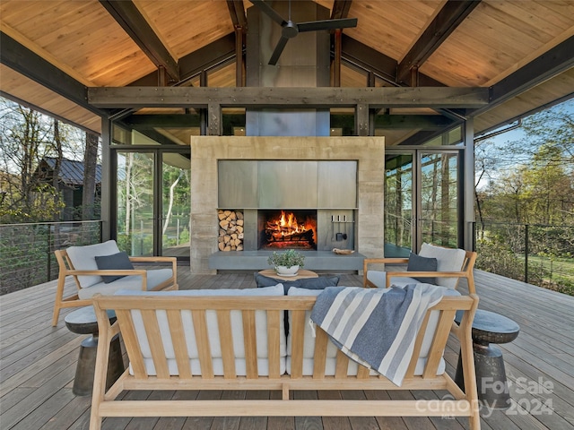 wooden terrace with an outdoor stone fireplace