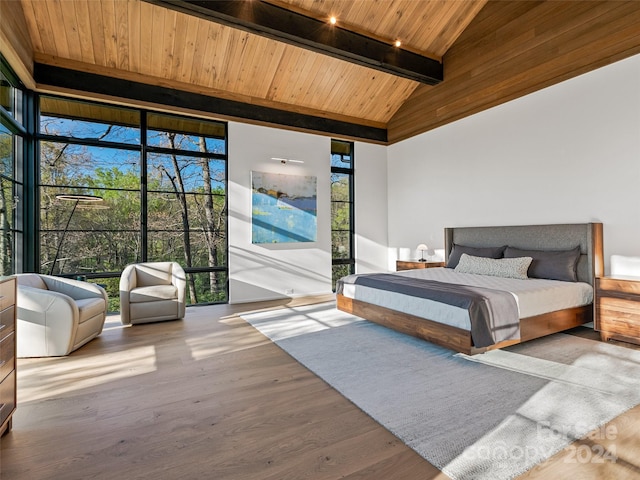 bedroom featuring wood ceiling, wood-type flooring, high vaulted ceiling, and multiple windows