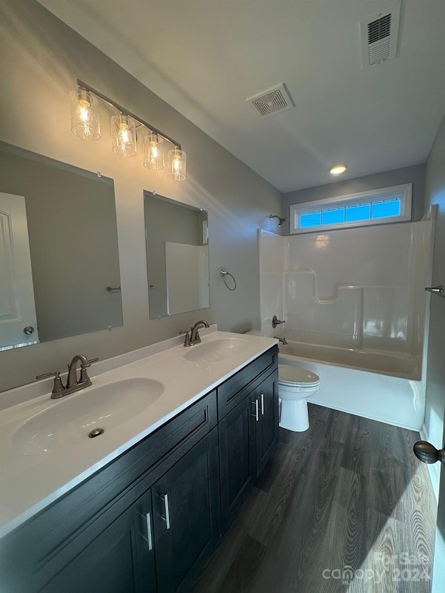 full bathroom with wood-type flooring, vanity, toilet, and shower / tub combination