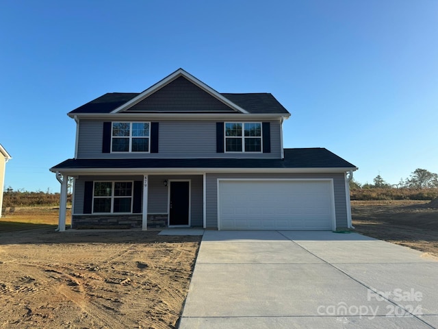 front of property with covered porch and a garage