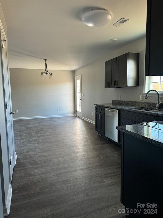 kitchen featuring stainless steel dishwasher, a notable chandelier, sink, and dark wood-type flooring