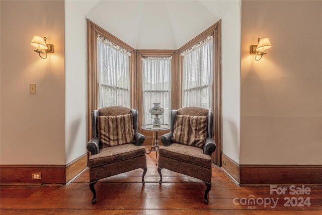 sitting room featuring vaulted ceiling and hardwood / wood-style flooring