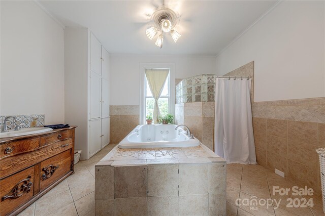 bathroom with plus walk in shower, ceiling fan, tile patterned floors, vanity, and ornamental molding