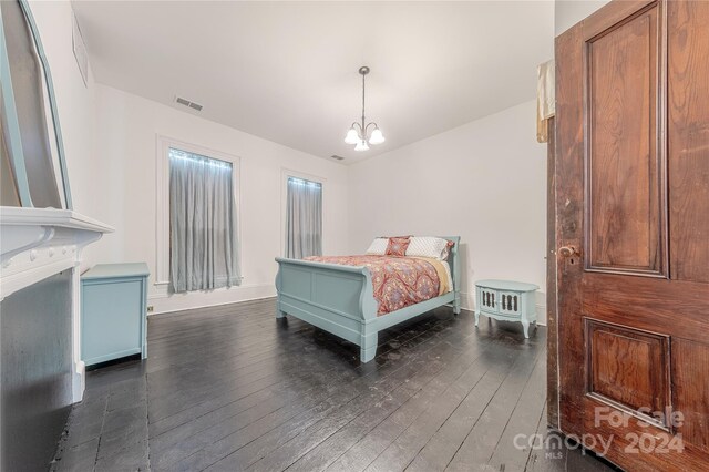 bedroom featuring a notable chandelier and dark hardwood / wood-style floors