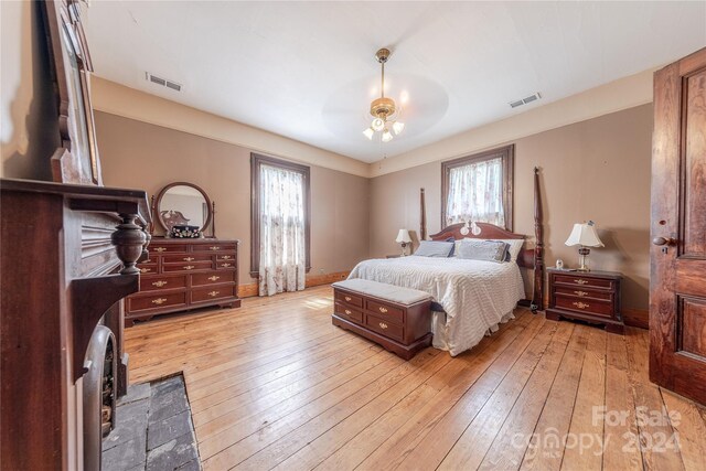 bedroom with light hardwood / wood-style flooring, multiple windows, and ceiling fan