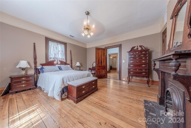 bedroom with light hardwood / wood-style flooring and ceiling fan