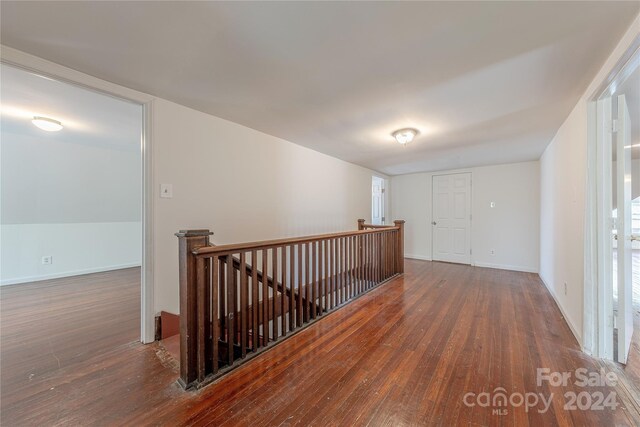 hall with dark wood-type flooring