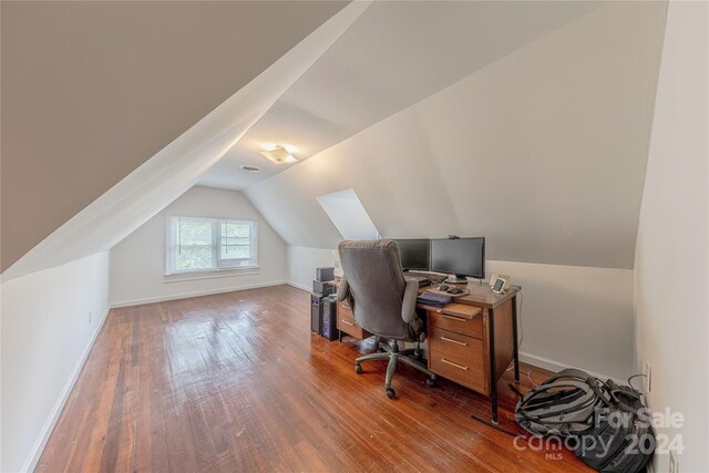 home office featuring hardwood / wood-style flooring and vaulted ceiling