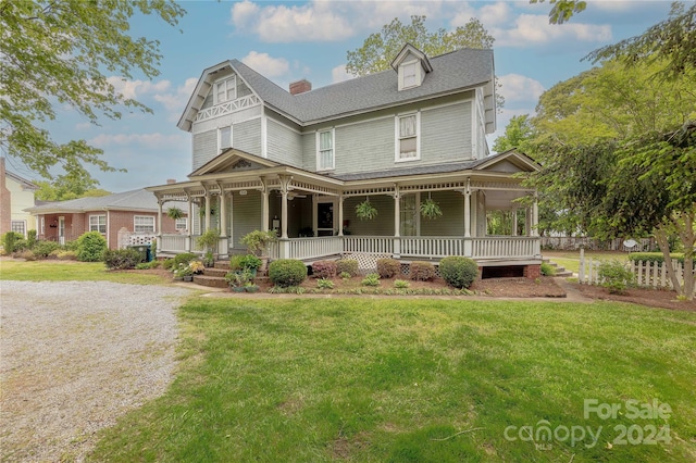 victorian-style house with covered porch and a front yard