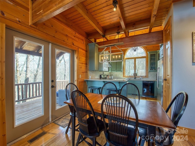 dining room with wood ceiling, plenty of natural light, beamed ceiling, and light wood-type flooring