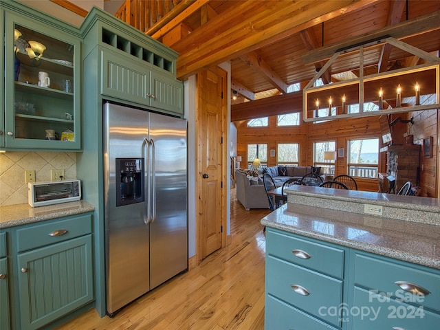 kitchen featuring beamed ceiling, light hardwood / wood-style flooring, wood ceiling, and high quality fridge