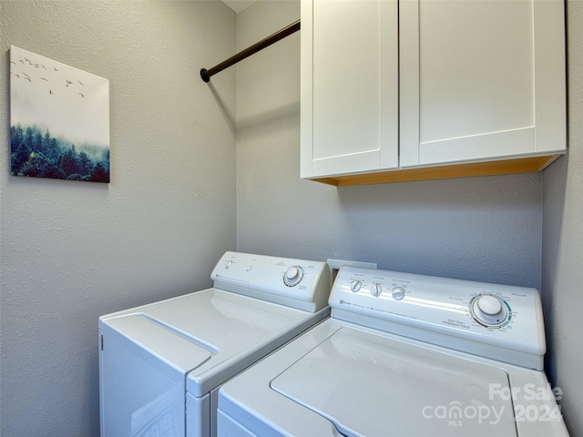 washroom with cabinets and separate washer and dryer