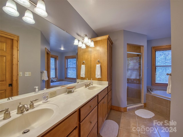 bathroom with double vanity, tile floors, and independent shower and bath