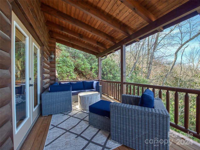 wooden terrace with an outdoor hangout area