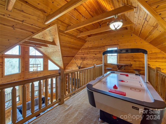 recreation room with lofted ceiling with beams, wooden ceiling, wood walls, and carpet flooring