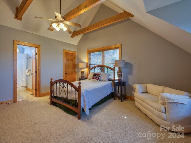 bedroom featuring light colored carpet, ensuite bath, ceiling fan, and vaulted ceiling with beams