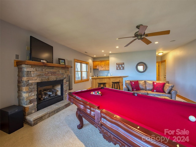 playroom featuring light carpet, ceiling fan, a fireplace, and pool table