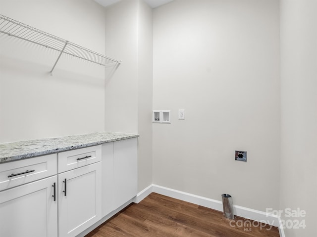 clothes washing area featuring cabinets, dark hardwood / wood-style flooring, hookup for a washing machine, and hookup for an electric dryer