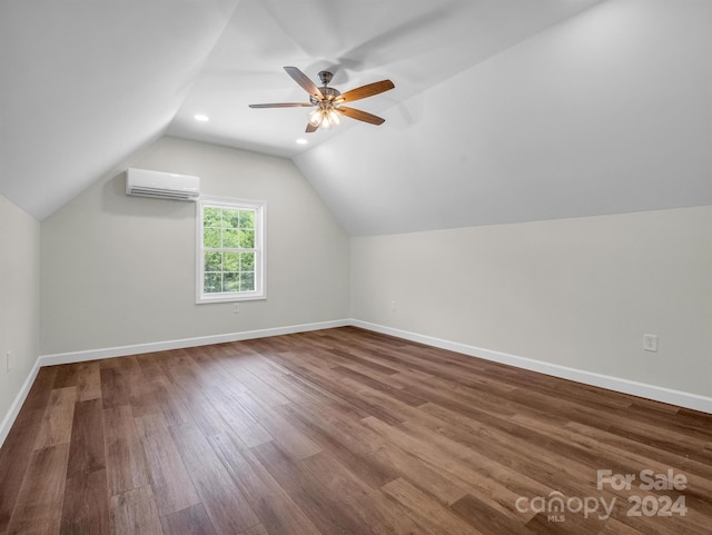 additional living space featuring an AC wall unit, wood-type flooring, lofted ceiling, and ceiling fan