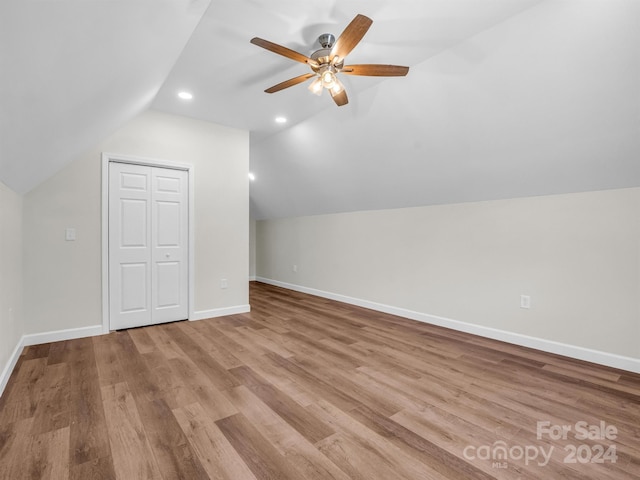 additional living space with ceiling fan, vaulted ceiling, and light hardwood / wood-style floors