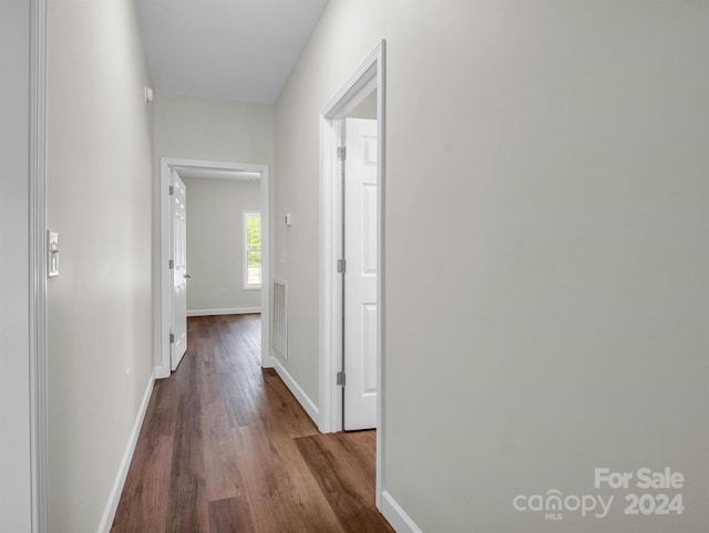 hallway with hardwood / wood-style floors