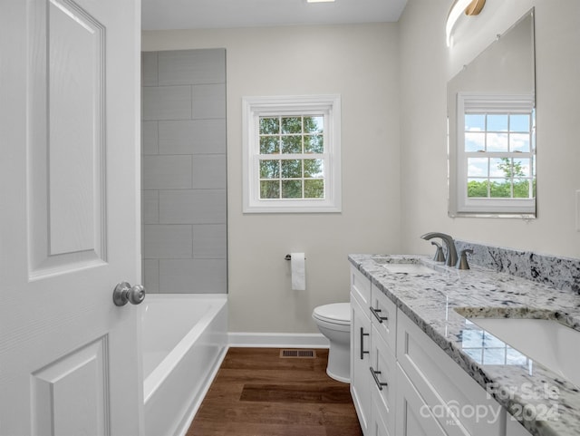 bathroom with toilet, hardwood / wood-style flooring, and vanity