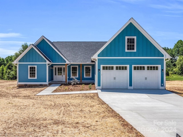 view of front of property featuring a garage and covered porch