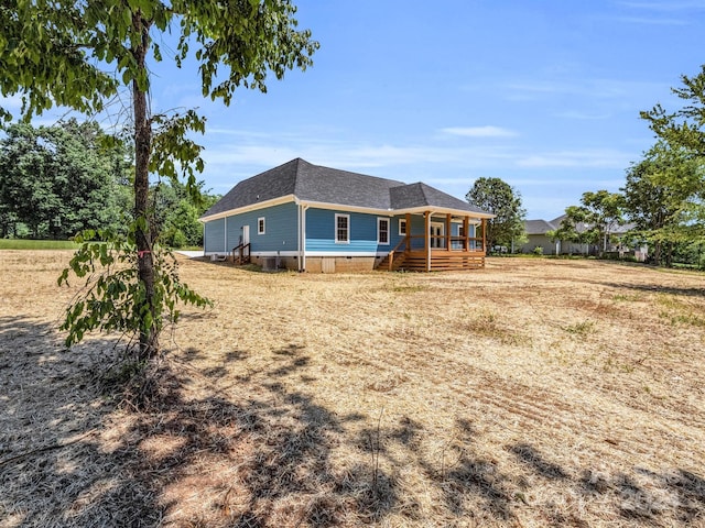 rear view of property with covered porch