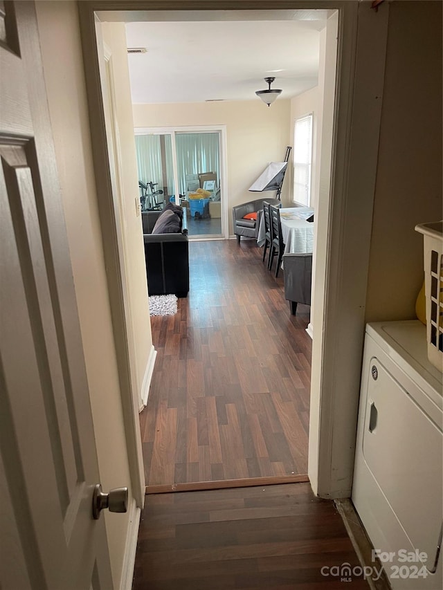 hall with dark hardwood / wood-style flooring and washer / dryer