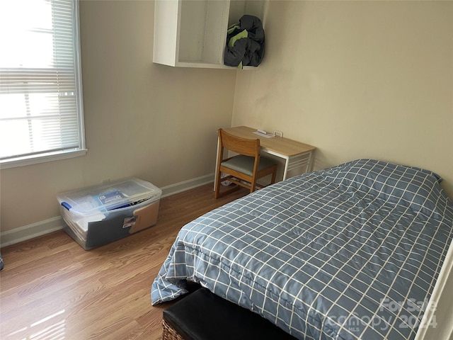 bedroom featuring light hardwood / wood-style flooring and multiple windows