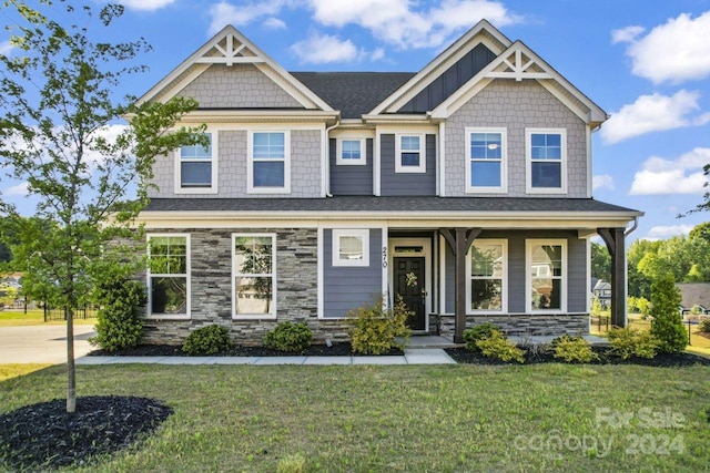 craftsman-style house with covered porch and a front yard