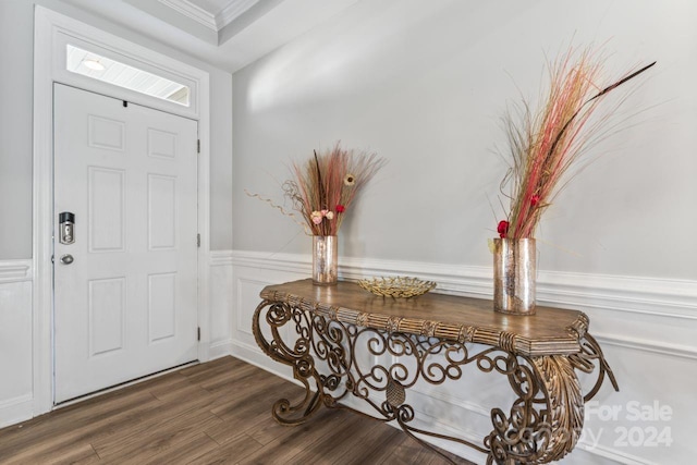 entryway with crown molding and dark hardwood / wood-style floors