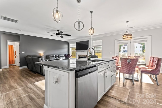 kitchen featuring plenty of natural light, dishwasher, wood-type flooring, a kitchen island with sink, and sink