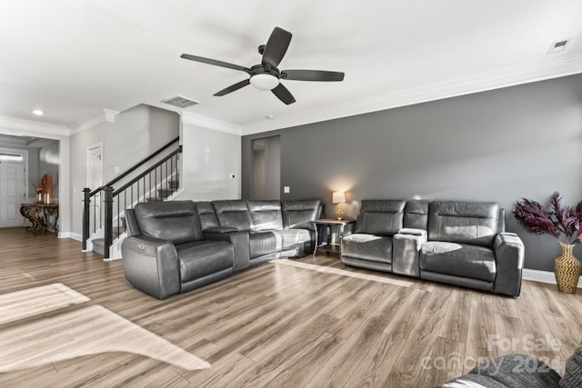 living room featuring ornamental molding, ceiling fan, and hardwood / wood-style floors