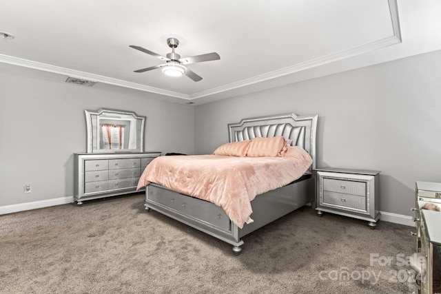 carpeted bedroom with a raised ceiling, ceiling fan, and crown molding