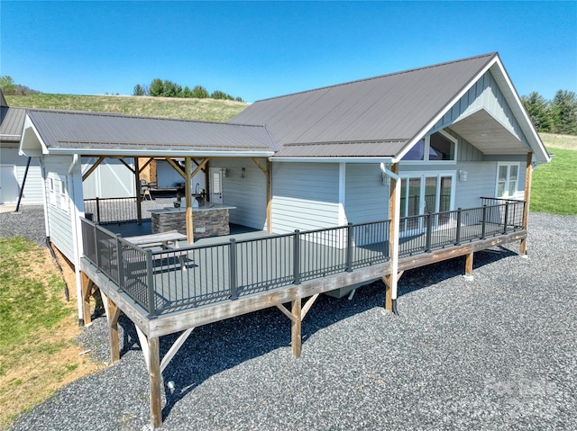 view of front facade with an outdoor hangout area and a wooden deck