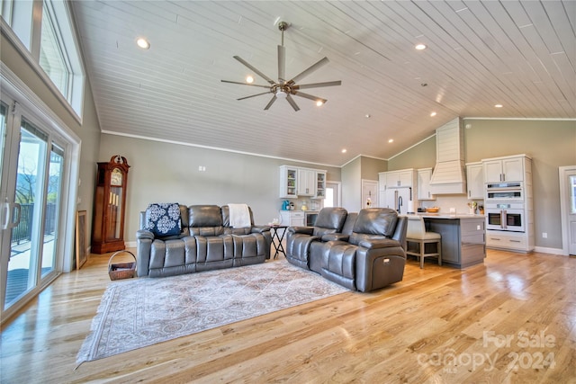 living room featuring ornamental molding, light hardwood / wood-style floors, ceiling fan, and high vaulted ceiling