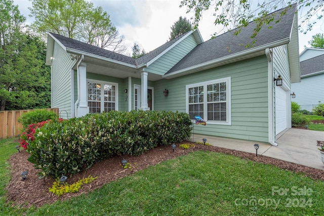 view of front facade with a front lawn and a garage