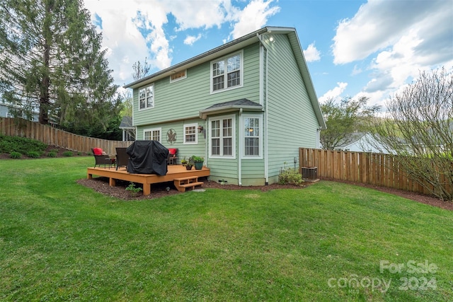 back of house with a deck, central AC, and a lawn