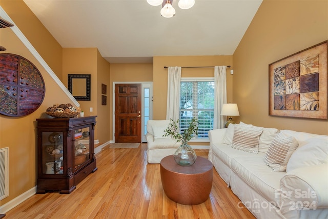 living room with lofted ceiling and light wood-type flooring