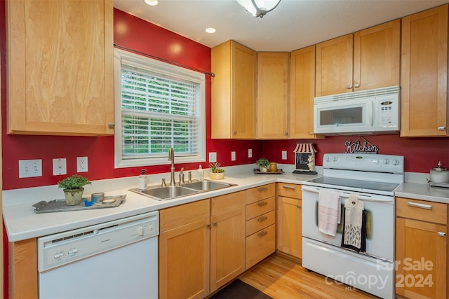 kitchen featuring sink, white appliances, and light wood-type flooring