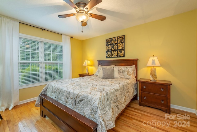 bedroom with light hardwood / wood-style flooring and ceiling fan