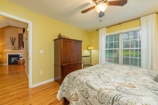 bedroom with ceiling fan and light wood-type flooring