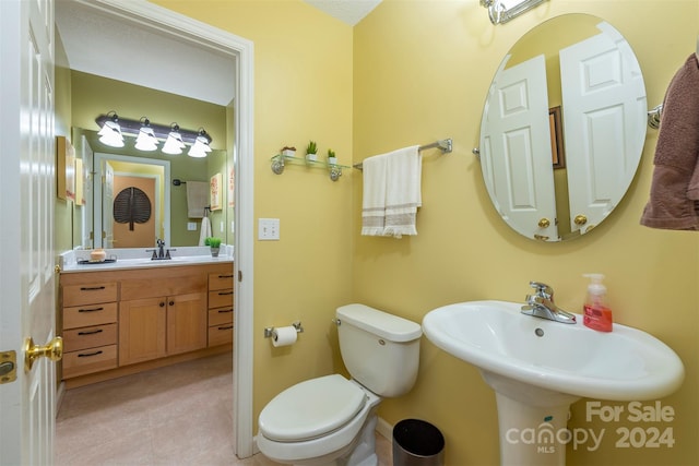 bathroom with sink, toilet, and tile floors