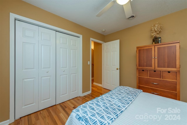 bedroom with a closet, ceiling fan, and light wood-type flooring