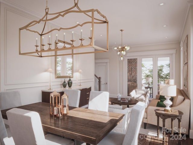 dining area featuring ornamental molding, an inviting chandelier, and wood-type flooring